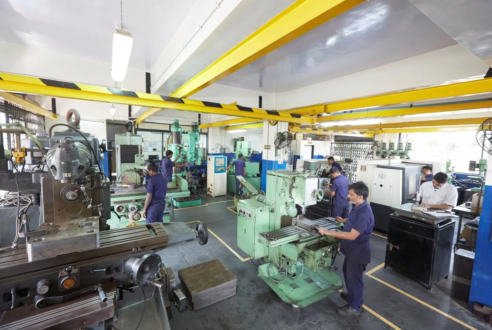 The Pratishna machine shop in Mumbai — milling machines, radial drills and surface grinders in one bay