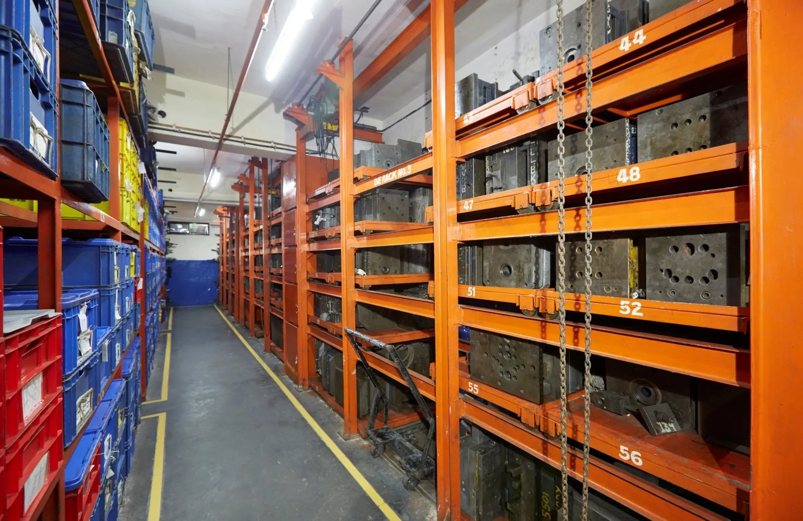 Numbered die racks holding customer moulds in the storage bay